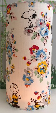 a lampshade with snoopy and flowers on it