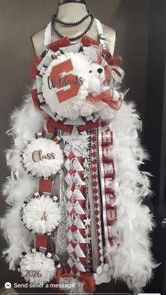 a dress made to look like a teddy bear with red and white feathers on it