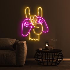 a neon sign in the shape of a hand holding a video game controller