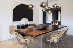 a dining room table with chairs and a bowl on it