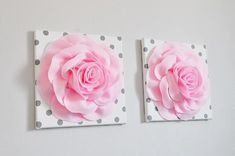 two pink roses are mounted on polka doted canvases, one is in the shape of a flower