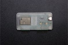 the back side of an electronic device on a black surface