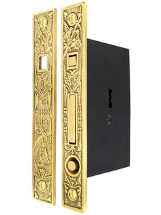 the door handle is gold and has an intricate design on it's front side