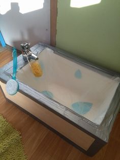 an empty bathtub is wrapped in plastic and sits on the floor next to a mirror