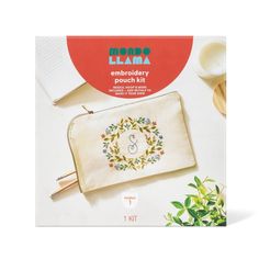 the embroidered pouch kit is sitting on top of a table