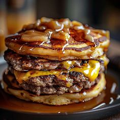 a stack of pancakes covered in cheese and syrup