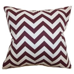 a maroon and white chevroned pillow on a white background