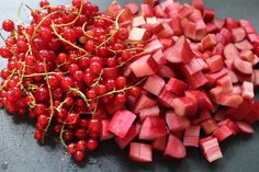 chopped radishes and cherries on a cutting board