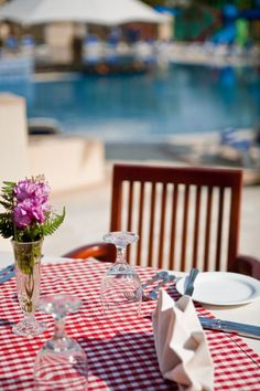 the table is set with flowers and wine glasses