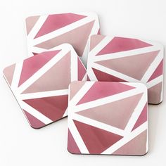 four coasters with pink and white designs on them