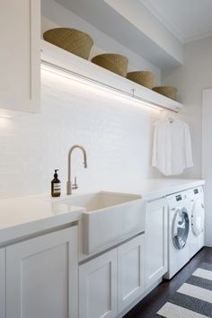 a washer and dryer in a white laundry room