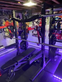 a gym room with purple lighting and various exercise equipment on the wall, including a bench