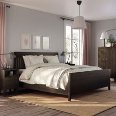 a bed room with a neatly made bed next to a dresser and window sill