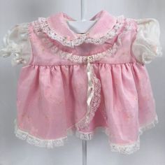 Pink dress with sheer overlay with subtle floral pattern. Lace trim throughout. Such a beautiful dress. Two button closures on back. Bow is on with safety pin. Size: No size listed but looks around 3-6 months. Please see measurements below to ensure fit. Measurements (approximate): Shoulder to Hem: 10.5" Armpit to Armpit: 11.5" Brand: The Littlest Mushroom Be sure to check out my shop! New items added often! https://www.etsy.com/shop/AutumnRoseArtVintage White Ribbon, Lace Detail, Ribbon Bows, Pink Dress, Lace Trim, Baby Girl Clothes, Beautiful Dresses, Baby Clothes, Girls Dresses