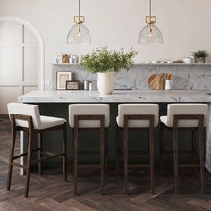 a kitchen with marble counter tops and bar stools