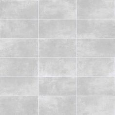 a white tile wall that has been painted in shades of light gray and dark grey