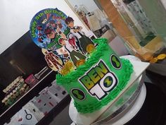 there is a cake with the name ben 10 on it in front of a party sign