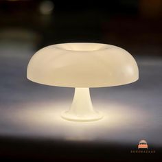 an illuminated mushroom lamp sitting on top of a table