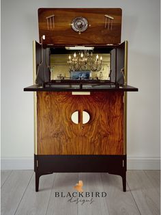 an old fashioned cabinet with a chandelier in the center and lights on top