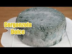 a large piece of cheese sitting on top of a white plate with the words gorgonzoola dolce