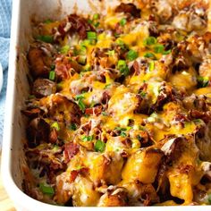 a casserole dish with meat, cheese and green onions