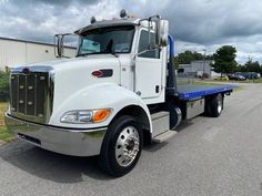 a white semi truck is parked on the street