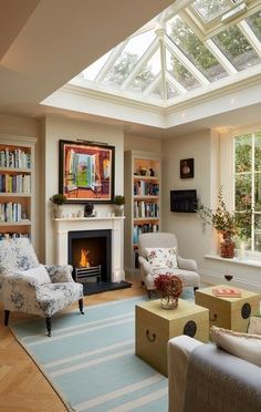 a living room filled with furniture and a fire place in the middle of a room