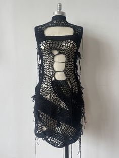 a mannequin is covered in black crochet