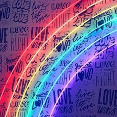 the word love is written in rainbow colors