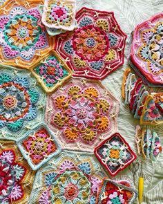 crocheted granny grannys are arranged on a bed