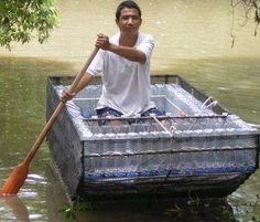 a man sitting on top of a boat filled with water and holding a wooden paddle