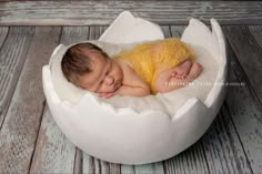 a baby is sleeping in an egg shell