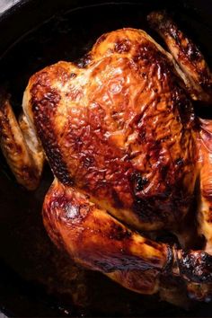 a roasted chicken in a black pan