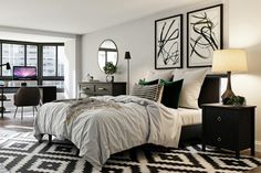 a bedroom with black and white decor in it