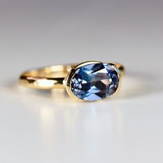 This beautiful oval lab grown color change sapphire ring was made of 8mmx6mm oval sapphire stone in 14k gold half bezel bezel setting and 14k yellow gold 2mm hammered band. It's perfect as a solitaire engagement ring or statement ring. DETAILS Ring Band: 14K YELLOW GOLDRing Band size: 2mm wide x 1mm thick half roundRing Band is hammered or smooth by requested.Gemstone: Lab grown color change sapphireGemstone size and cut: 6x8mm oval cutCarat weight : 1.25 ct. weightGemstone Quality : AAA *** All Sapphire Ring Bezel Set, Half Bezel Sapphire Ring, East West Oval Sapphire Ring, East West Sapphire Engagement Ring, Bezel Set Sapphire Ring, Bezel Sapphire Ring, Bezel Sapphire Engagement Ring, East West Half Bezel, Sapphire Bezel Ring