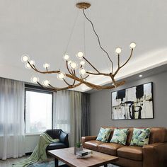 a living room filled with furniture and a chandelier hanging over the top of it