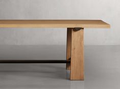 a wooden table sitting on top of a gray floor