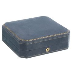 a small blue box with gold trimmings on the lid and bottom, sitting against a white background