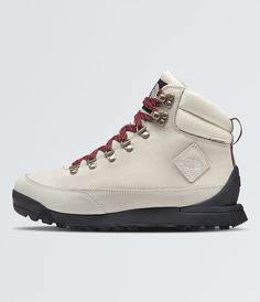 a pair of white hiking boots with red laces on the outstretches