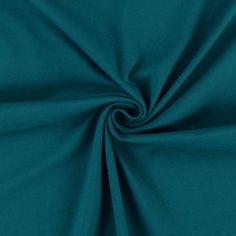 a close up shot of the teal green fabric that is very soft and smooth