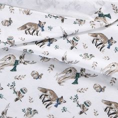 the fabric has animals on it and is white