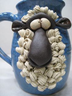 a ceramic sheep head on top of pasta noodles in a blue vase with brown eyes