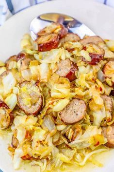 a white plate topped with cabbage and sausage