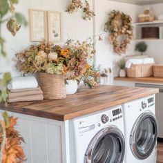 a washer and dryer sitting on top of a wooden counter in a kitchen