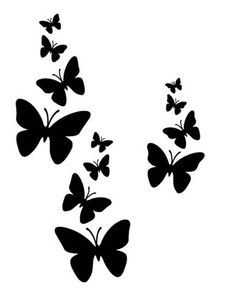 several black butterflies flying in the air