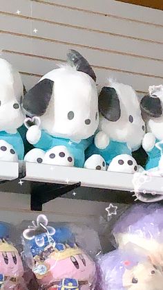 several stuffed animals are on display in a store shelf with other plush toys behind them