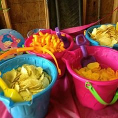 several buckets filled with different types of food