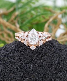 an engagement ring on top of a pile of dirt