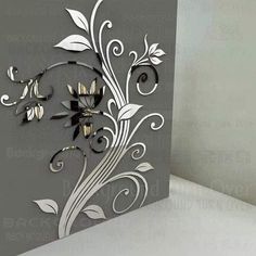 an artistically designed greeting card with flowers and swirls on the front, in silver