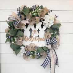 a wreath with the word welcome hanging on it